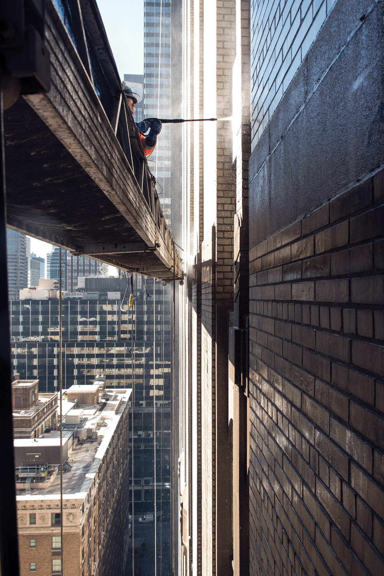 Construction Worker Power Washing the Waldorf Astoria's Facade