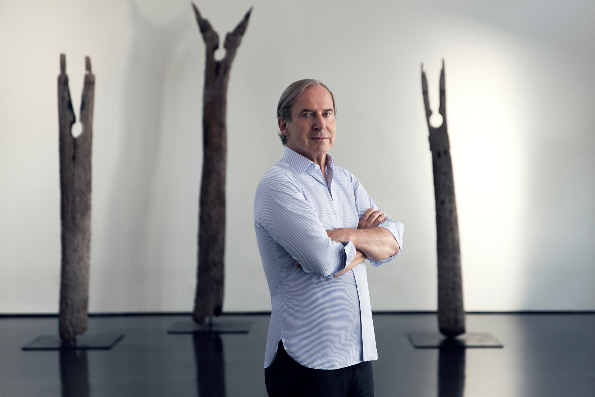 Simon De Pury Standing in Front of Art Pieces for the Waldorf Astoria Tower